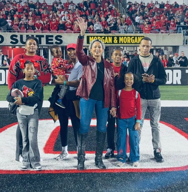 An honoree and family recognized on the field at a University of Louisville game
